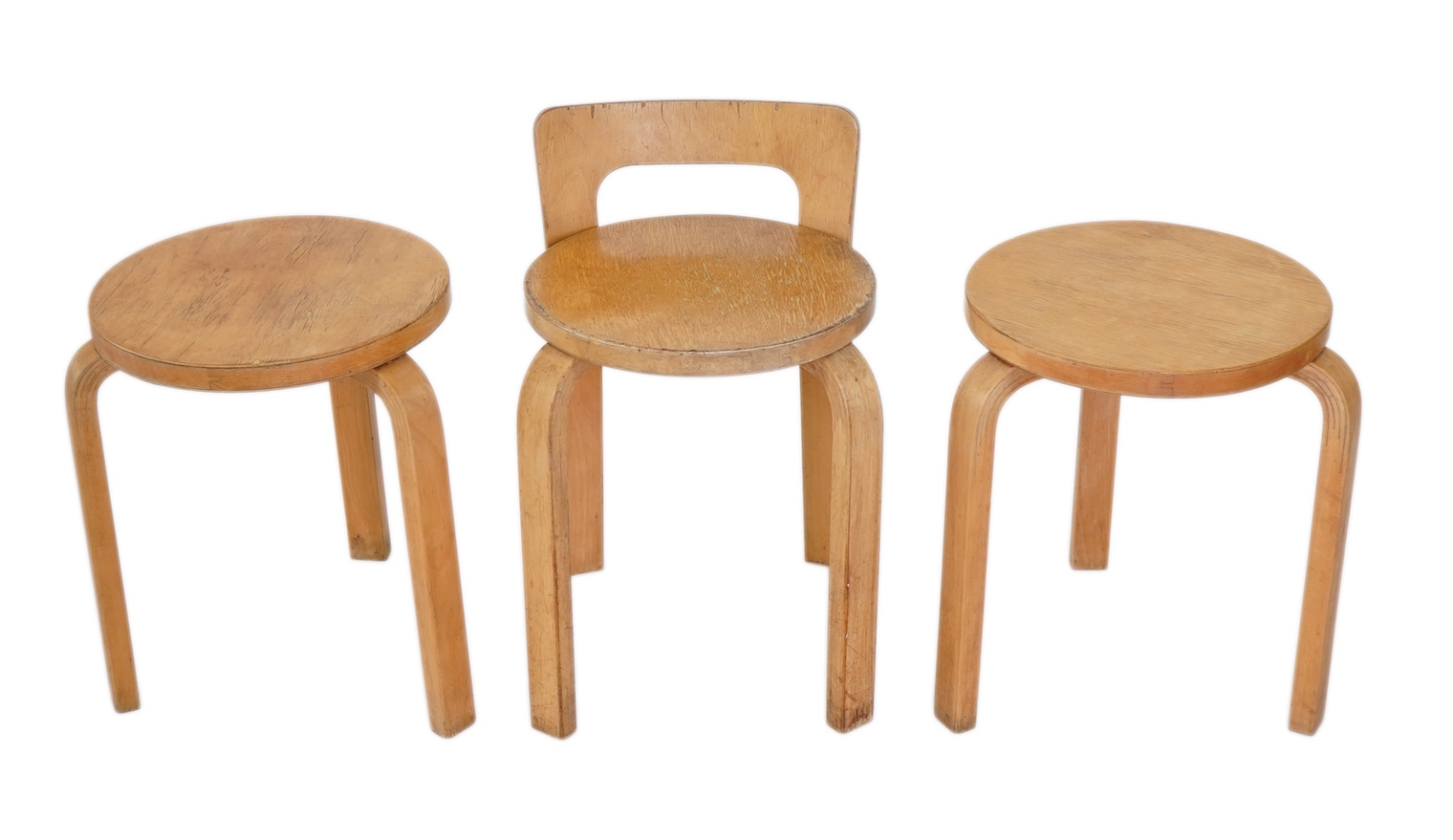Alvar Aalto (Finnish 1898-1976) for Artek, distributed by Finmar: A pair of 'Model 60' stools and a similar 'K65' stool